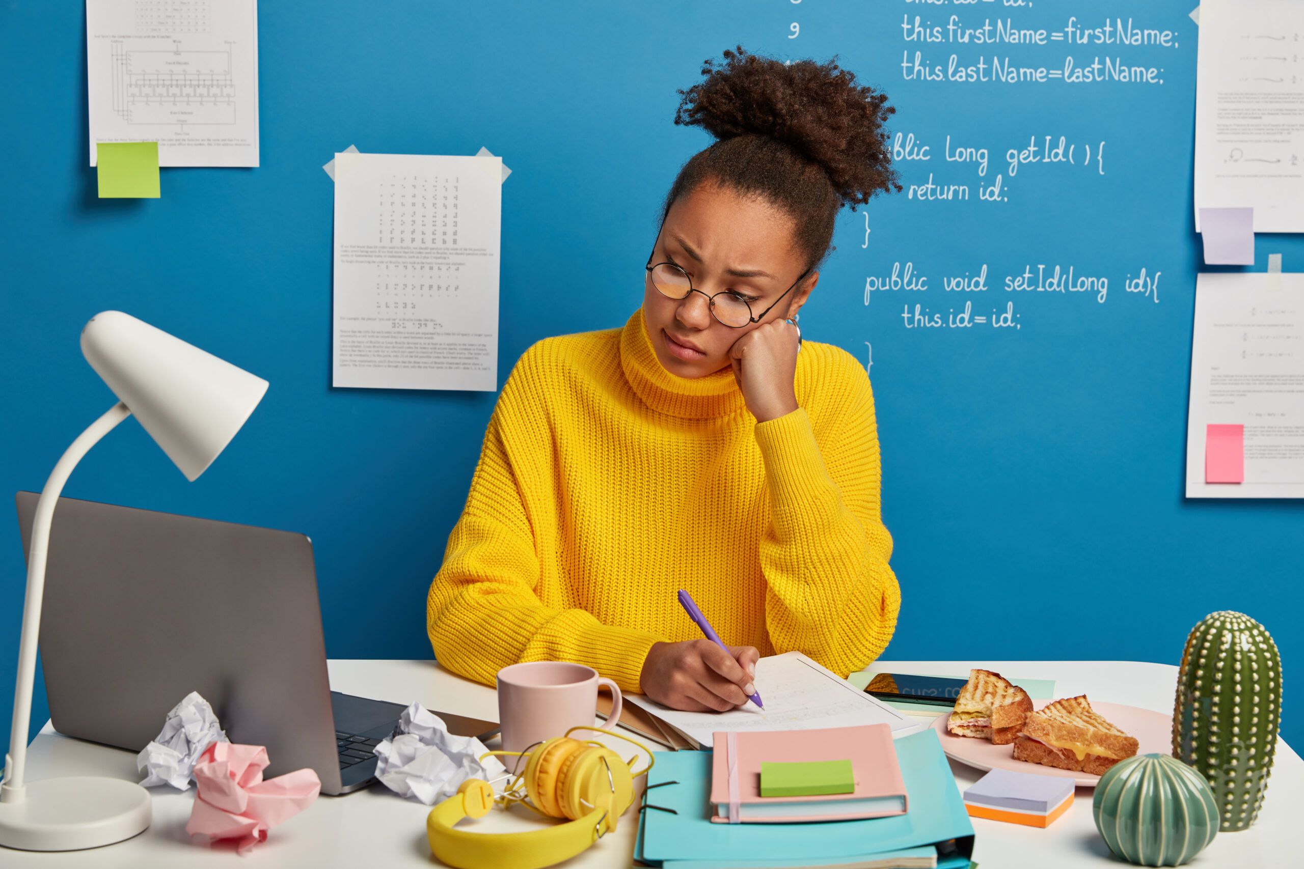 Student writing a scholarship essay at a study desk in 2027